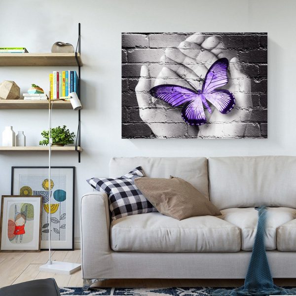 Purple Butterfly On Hand On Gray Wall